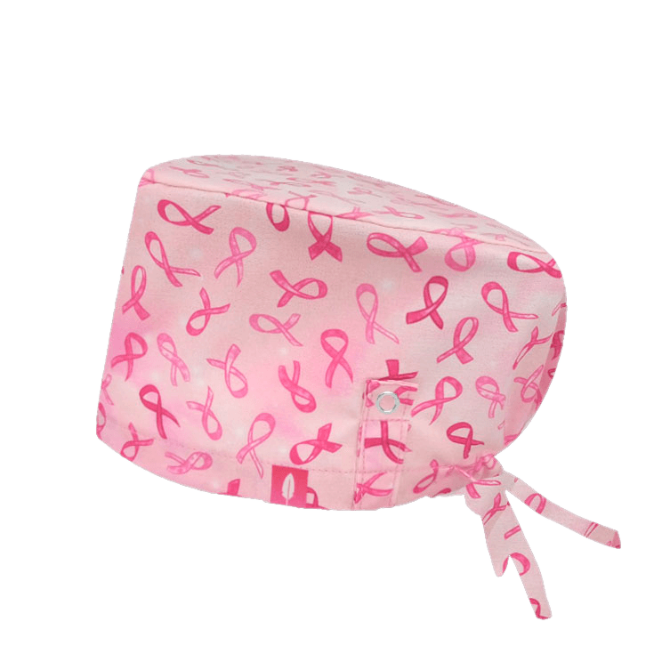 Gorro quirúrgico AGATHE con lazo rosa, símbolo de la lucha contra el cáncer de mama, y tecnología Click & Mask para un ajuste cómodo de mascarilla.