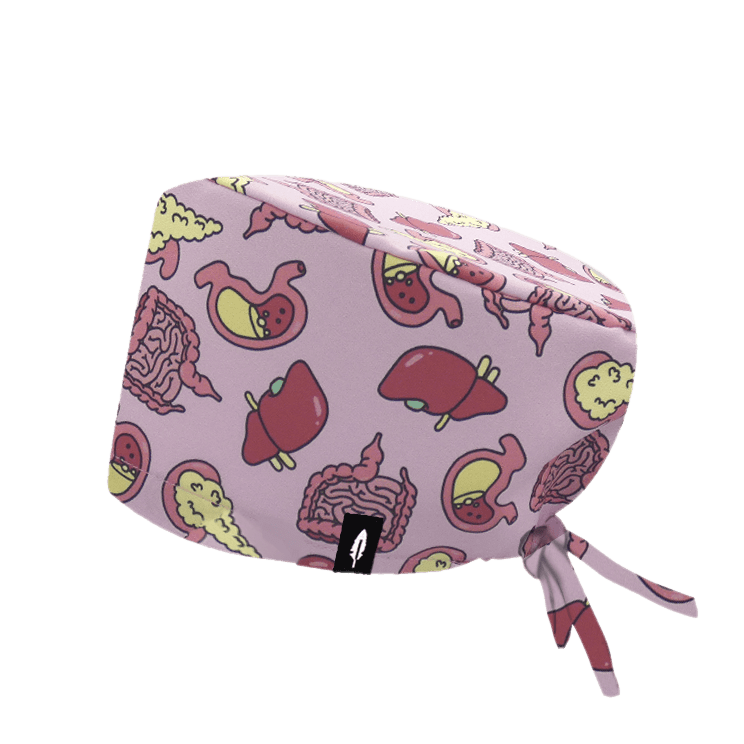 Gorro quirúrgico Digestive con diseño del sistema digestivo en fondo rosado y toques rosados y amarillos, fabricado en poliéster transpirable.