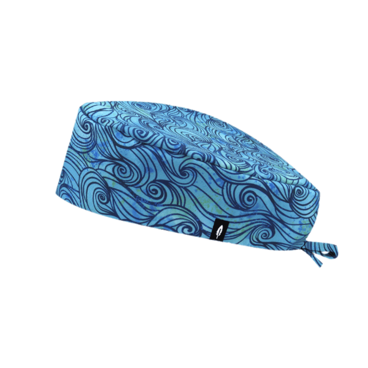  Gorro de quirófano ULUWATU de Robin Hat, con diseño inspirado en las olas del mar y en tonos azules.