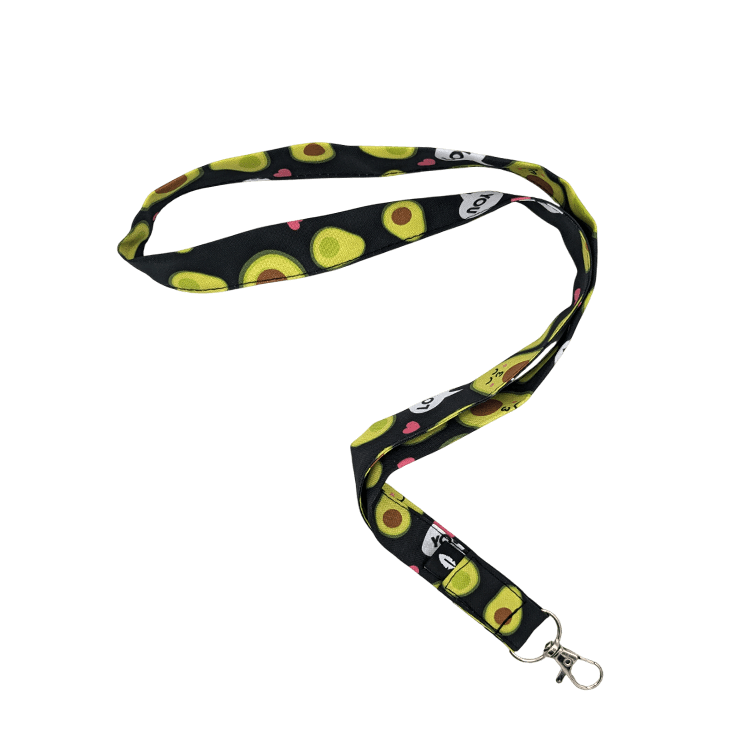 Lanyard AVOCADO de Robin Hat, fabricado en poliéster técnico, con divertidos dibujos de aguacates sobre fondo negro, ideal para uso diario.